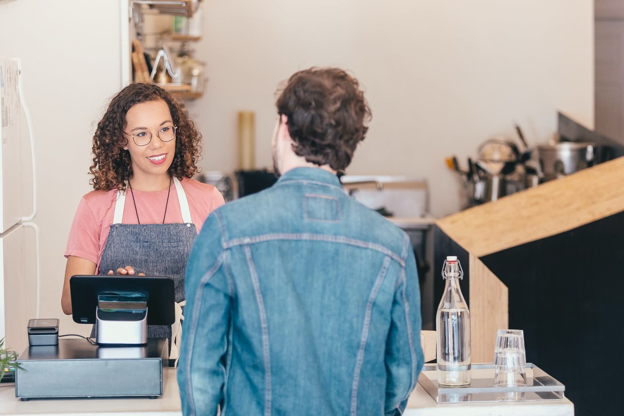 A Shopify POS countertop: a tablet on a stand, a card reader dock, a cash drawer and a receipt printer