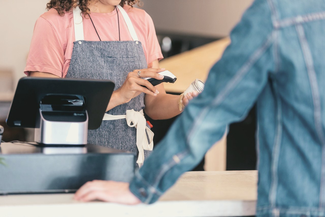 A barista scans a product at a Shopify POS counter